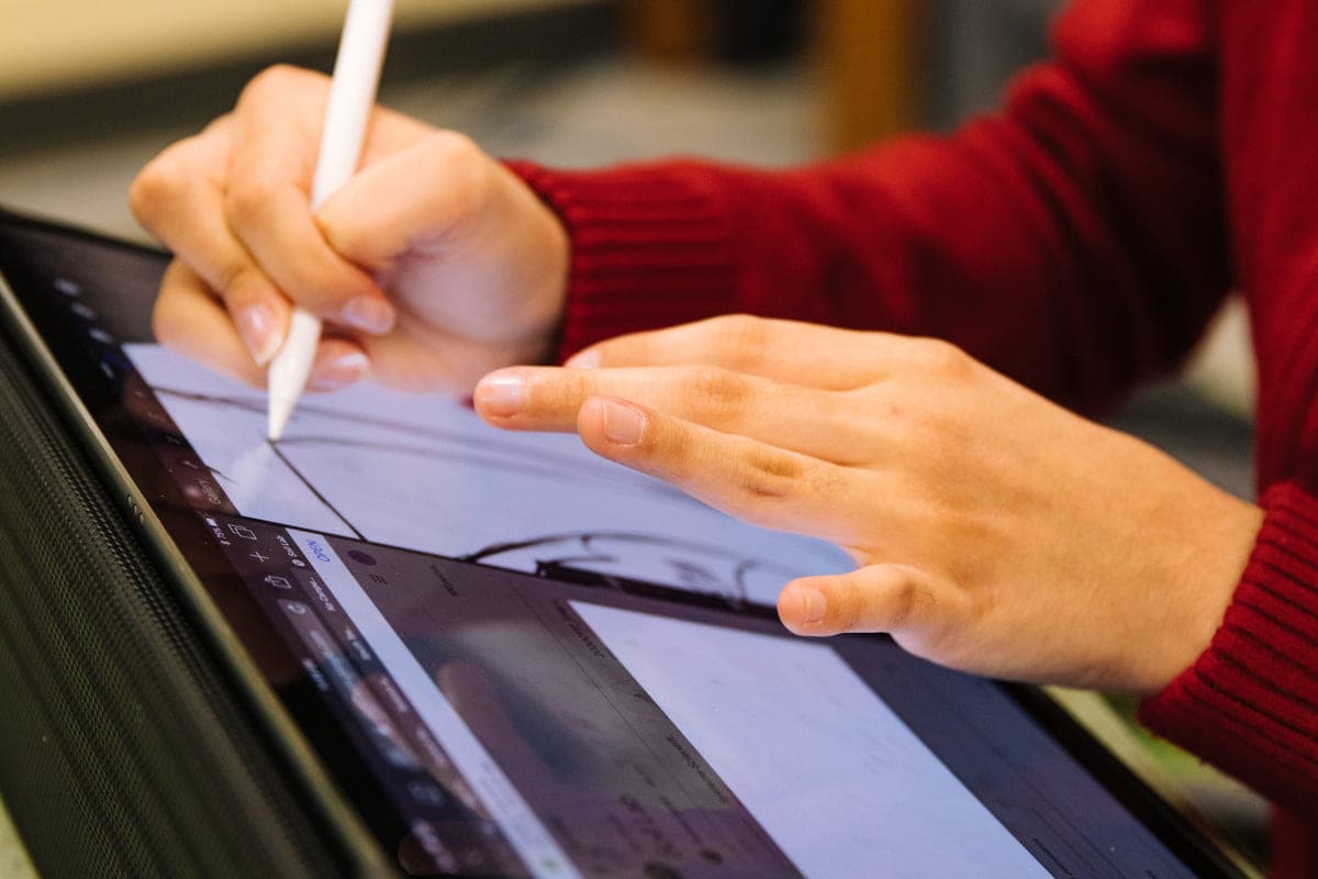 A designer sketching on a tablet